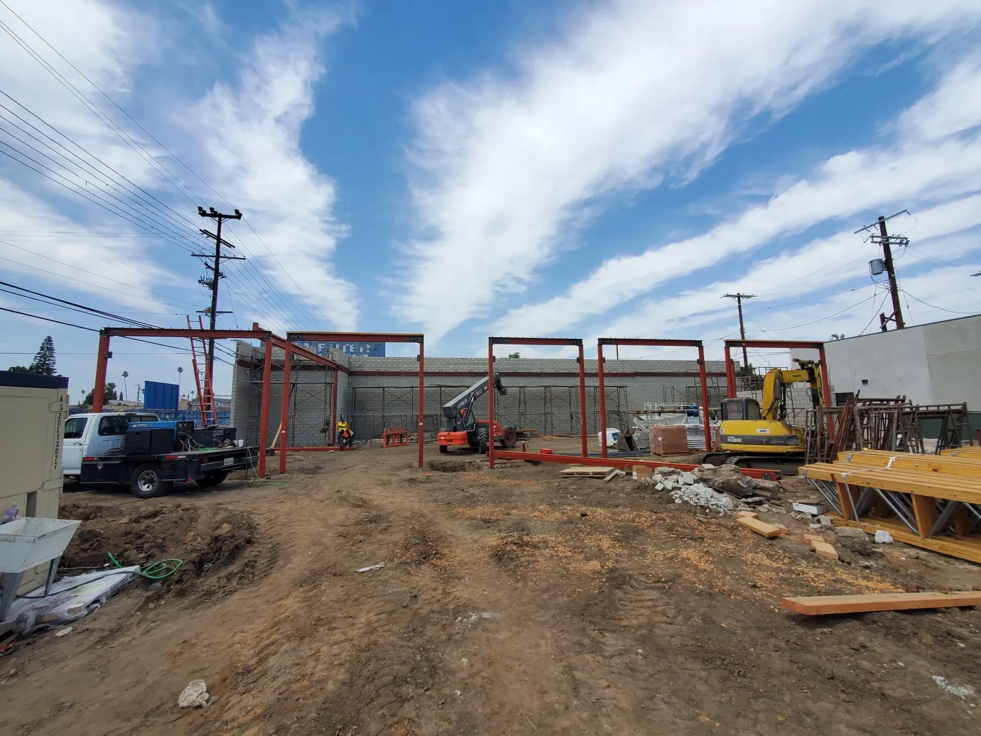 A construction site with trucks and equipment on the ground.