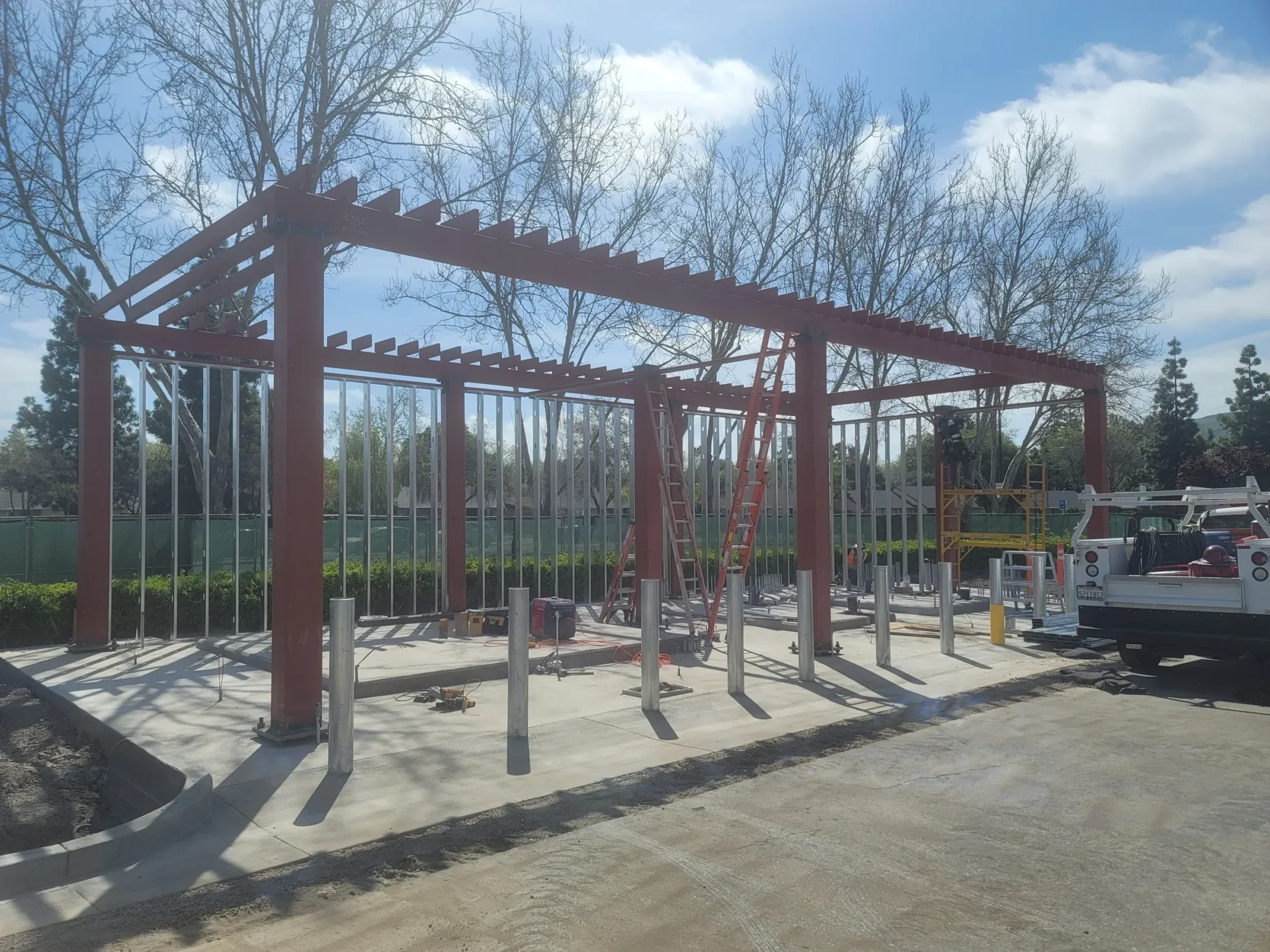 A large metal structure with trees in the background.