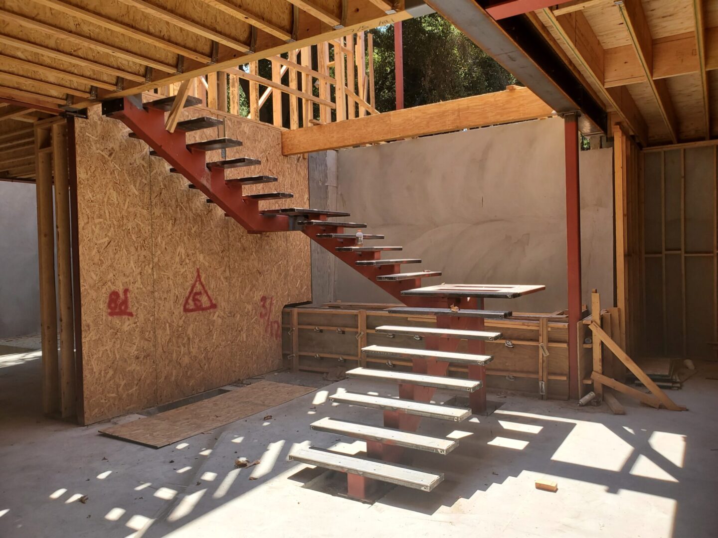 A staircase that is under construction in the middle of a room.